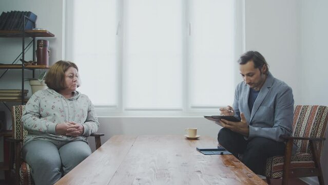Sociological survey of the population at home. Employee interviewing housewife at home