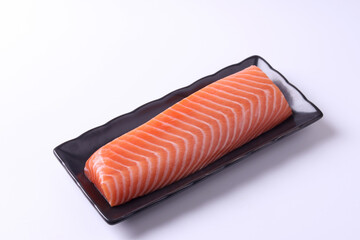 
Salmon sashimi on a wooden chopping board, white background