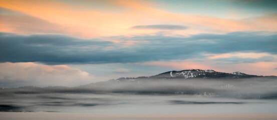 A pastel sunrise over a ski resort in winter