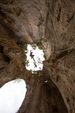 Rock climber in Grotta dell Edera, Finale Ligure, Liguria, Italy