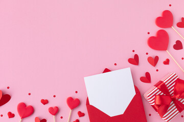 Valentine day holiday background with gift, envelope, paper card and various red hearts for love romantic message. Flat lay style.. - obrazy, fototapety, plakaty