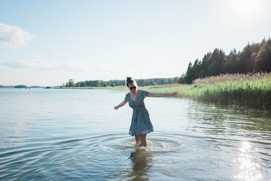 woman dancing in the water at the beach