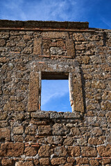 window opening in the stone wall of a ruined building in Bagnoregio