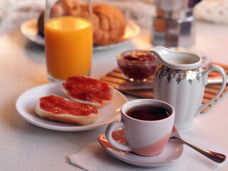 Fototapeta na wymiar Continental breakfast with buns with jam and coffee.
