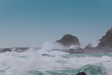 Fototapeta na wymiar Storm waves crashing onto Cornish Rocks Dollar Cove, The Lizard, Cornwall