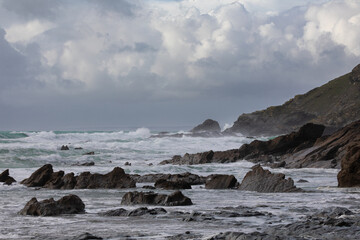 Fototapeta na wymiar Storm waves crashing onto Cornish Rocks Dollar Cove, The Lizard, Cornwall