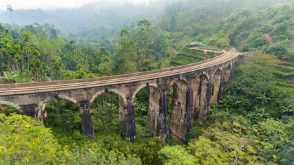 Fototapeta na wymiar Aerial view of famous Nine Arches Bridge of Sri Lankan railway. The surrounding area has seen a steady increase of tourism due to the bridge's architectural ingenuity.