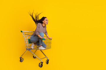 Full size profile portrait of excited crazy person sit trolley ride empty space isolated on yellow...