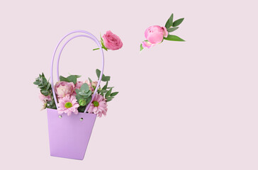 Flying basket with beautiful flowers on light background