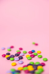 A pink web background with coloful chocolate candies perfect for a party, birthday or Valentines's day