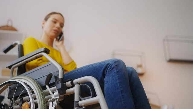 Young woman with physical disability having serious phone call, problems