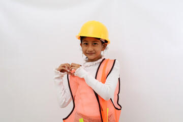 Cute Asian little girl in the construction helmet as an engineer making heart shape with her hands. Isolated on white