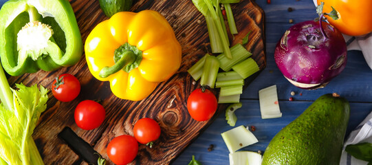 Various fresh vegetables on blue table. Diet concept