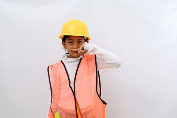 Unhappy Asian little girl in the construction helmet as an engineer feeling bad smell while...