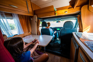 Children seated in back seats while mother driving in motorhome