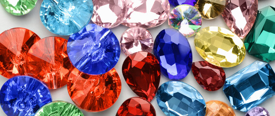 Many different precious stones for jewellery on light background