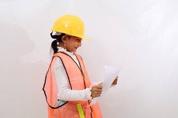 Side view of Asian little girl in the construction helmet as an engineer standing while holding a blueprint design paper. Isolated on white