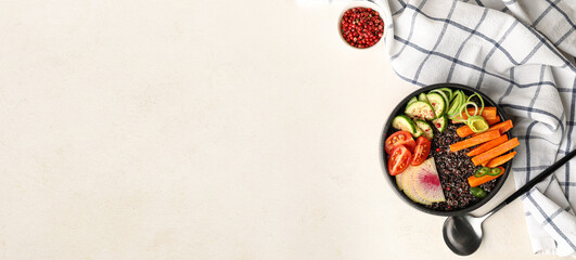 Bowl with tasty quinoa salad on light background with space for text, top view