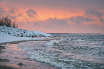 Frosty winter morning at Baltic sea shore in Riga. Beautiful landscape of seaside covered in snow and ice.