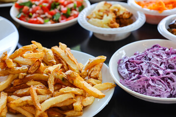 Plates with tasty food on black table, closeup
