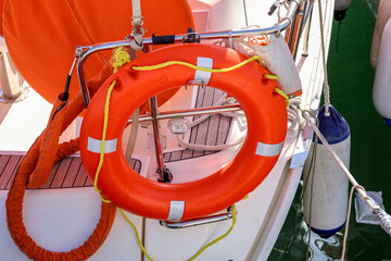Modern yacht with ring buoy at pier