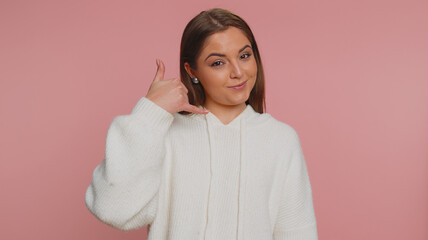 Call me, here is contact number. Young pretty woman in white sweater looking at camera doing phone...