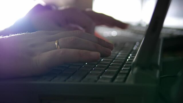 person typing on a laptop close-up