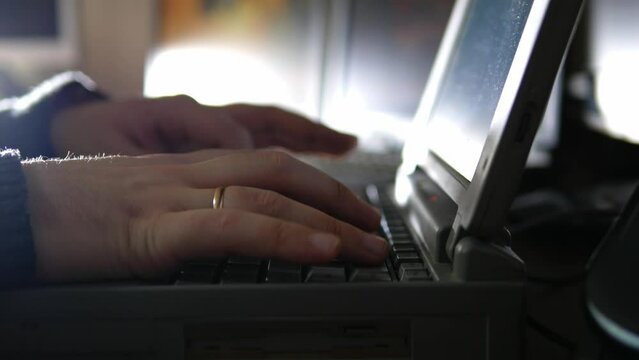 close up of a person typing on a laptop