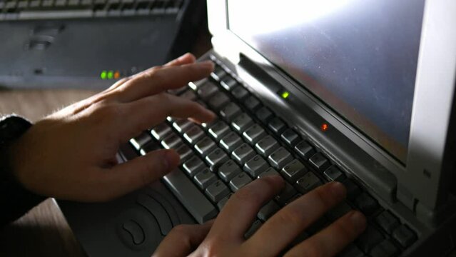 person typing on retro laptop