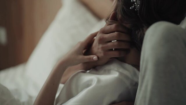 Сouple hugging and kissing on the bed. Love story, romantic concept. Close up.