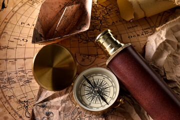 Fototapeta na wymiar Compass and spyglass on world map, closeup