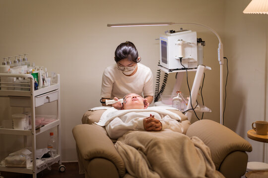 Beautician doing microcurrent therapy