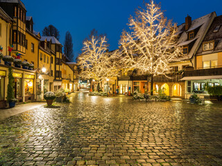Fototapeta na wymiar Nuremberg Christmas lights illuminating cobblestone and the whole street at night, Germany