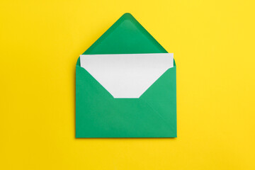 Green envelope with card on yellow background