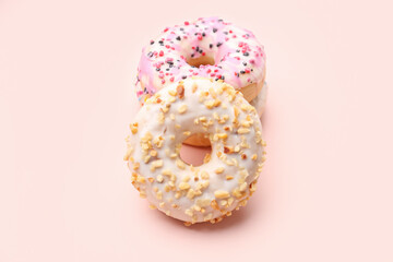 Tasty donuts on pink background
