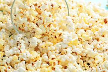 Overturned bowl of tasty popcorn, closeup