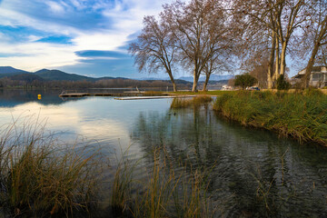Panoramic view of Lake Banyoles at sunset where tranquility remains and the lighting is prepared to offer us the best colors. Catalonia, Spain