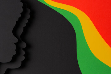 Black History Month color background. African Americans history celebration. Black paper cut people silhouette on abstract geometric shape red, yellow, green, black color background. Top view