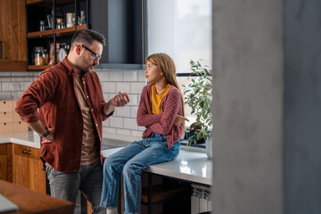 Young Caucasian father and daughter having a conflict at home.