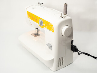 Electric sewing machine on a white background.