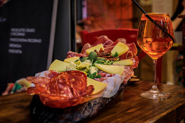 Italian antipasto platter and a glass of aperol spritz cocktail, Florence, Italy