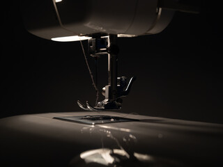 Electric sewing machine on a dark background.