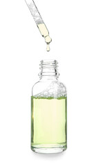 Dripping of natural serum into bottle on white background