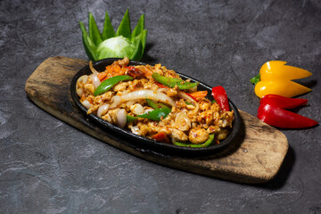 Chicken sizzling served in dish isolated on grey background top view of indian and bangladesh food