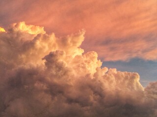 Captures a stunning cloud formation during sunset, suitable for backgrounds, naturerelated designs,...