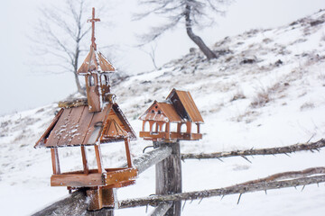 Velika planina mountain 1666 m in Kamnik Savinja Alps in Slovenia, winter hiking in herdsmen’s huts village covered with snow