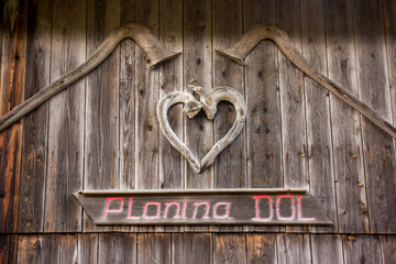 Velika planina mountain 1666 m in Kamnik Savinja Alps in Slovenia, winter hiking in herdsmen’s huts village covered with snow
