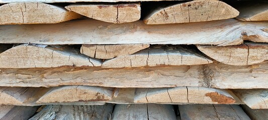 Close-up of a stack of firewood. Wooden texture boards background.