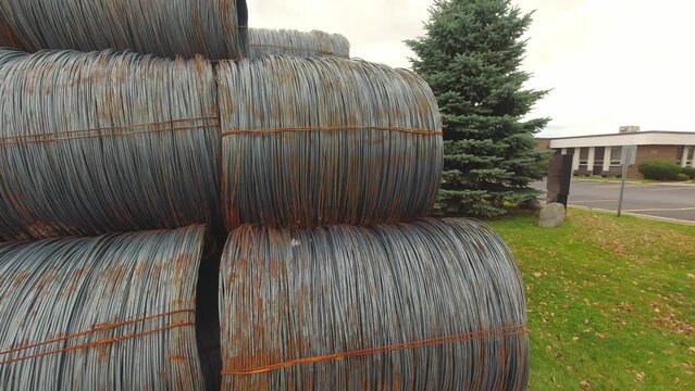 Metal corroded steel bars or rods in coils. Reinforcement for concrete construction sites. Steel wire rolls in construction site. Rolled steel stacked together in group of coiled wire.