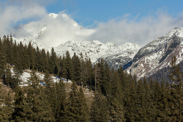 Velika planina mountain 1666 m in Kamnik Savinja Alps in Slovenia, winter hiking in herdsmen’s huts village covered with snow, with white mountain peaks